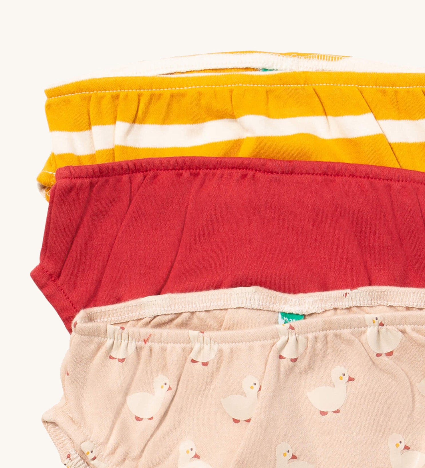 A close up of the Little Green Radicals puddle ducks underwear. Showing the trim detail and and a close up of each print and design on organic cotton fabric.