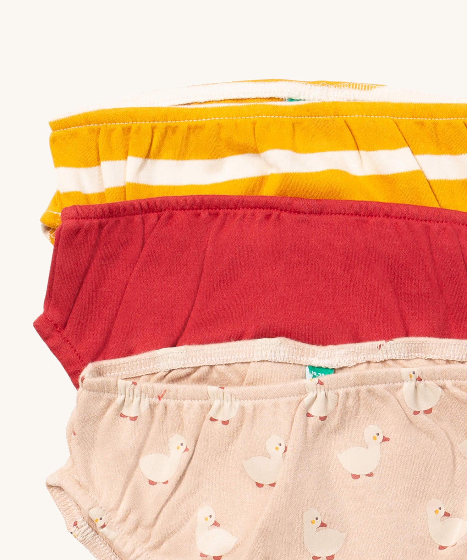 A close up of the Little Green Radicals puddle ducks underwear. Showing the trim detail and and a close up of each print and design on organic cotton fabric.