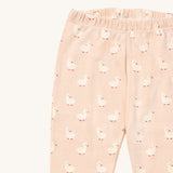 A close up of the Little Green Radicals puddle ducks pyjama bottom showing the elasticated waist band detail with a close up of the white puddle duck print detail on organic cotton fabric.