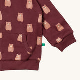 A close up of the Little Green Radicals reversible easy rider jacket in brown bears. Showing the pouch pocket detail and a close up of the cute brown bear print on GOTS organic cotton fabric