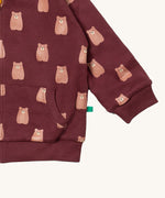 A close up of the Little Green Radicals reversible easy rider jacket in brown bears. Showing the pouch pocket detail and a close up of the cute brown bear print on GOTS organic cotton fabric
