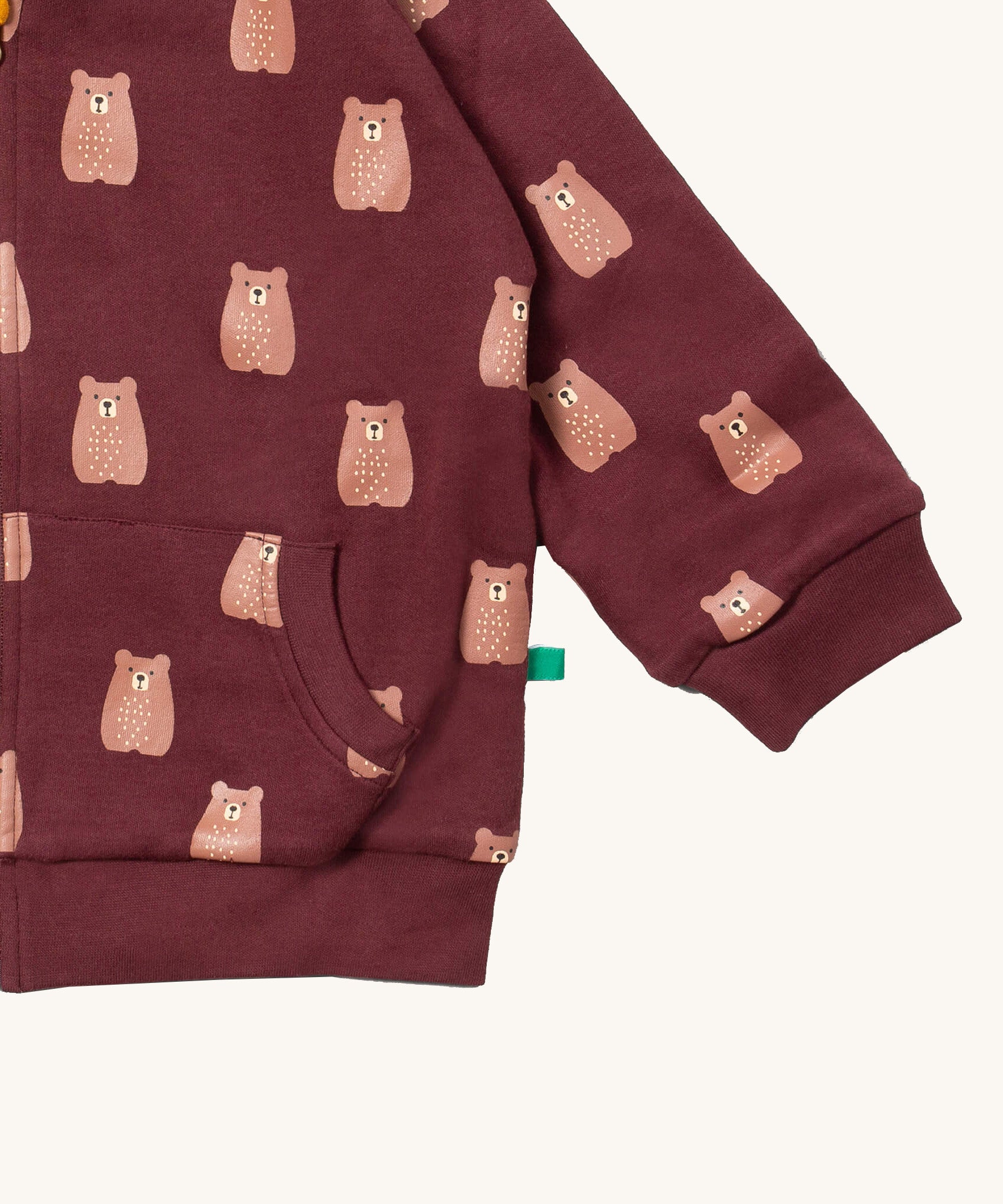 A close up of the Little Green Radicals reversible easy rider jacket in brown bears. Showing the pouch pocket detail and a close up of the cute brown bear print on GOTS organic cotton fabric