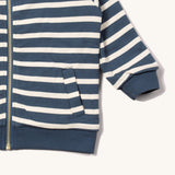 A close up of the Little Green Radicals reversible easy rider jacket in sleeping sheep. Showing the pouch pocket detail and a close up of the navy and white stripe design on GOTS organic cotton fabric