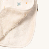 A close up of the sherpa fleece style inner from the sun and moon Little Green Radicals hooded blanket. Showing the fleece detail on white organic cotton fabric.