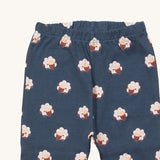 A close up of the Little Green Radicals sleeping sheep pyjama bottom showing the elasticated waist band detail with a close up of the white sheep print detail on navy organic cotton fabric.