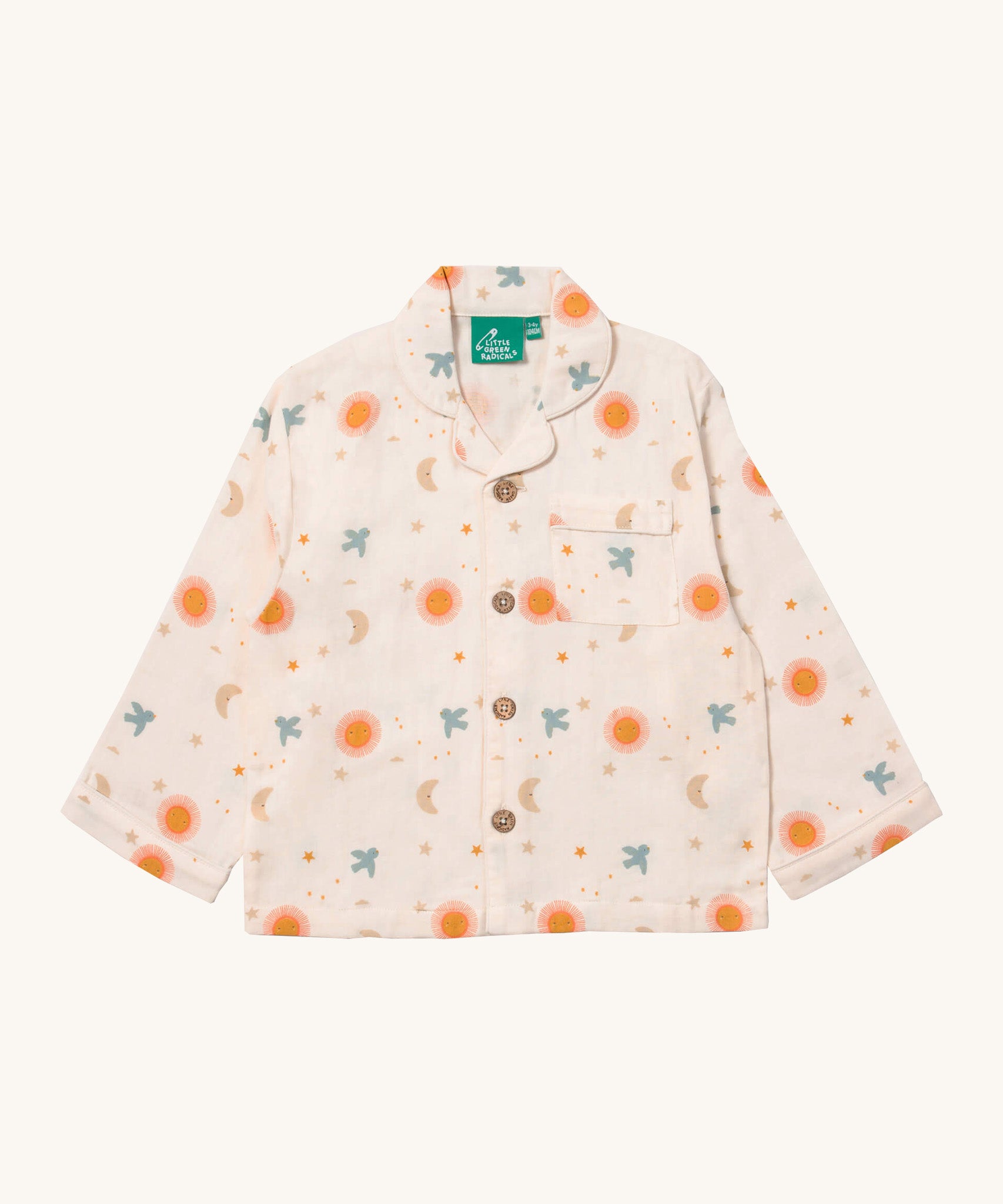 Little Green Radicals classic pyjama top from the moon and sun classic set. A GOTS organic cotton pyjama top in a classic shirt type style in light pink with prints of  a moon and sun with birds flying. Features button fasteners and a small chest pocket.