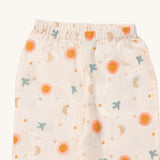 A close up of the Little Green Radicals classic pyjama bottoms from the moon and sun set. Showing the elasticated waistband detail and a close up of the starry night print with the flying blue birds on light pink organic cotton fabric.