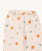 A close up of the Little Green Radicals classic pyjama bottoms from the moon and sun set. Showing the elasticated waistband detail and a close up of the starry night print with the flying blue birds on light pink organic cotton fabric.