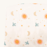 A close up of the sun and moon Little Green Radicals hooded blanket. Showing the cute sun and moon print detail on white organic cotton fabric.
