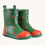 A pair of Little Green Radicals kid wellington boots. Natural rubber waterproof wellies in green with red apples printed all over. Features a red toe cap, gripped sole and pull-on tab for easy fitting