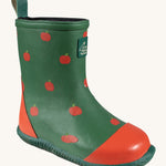 A single Little Green Radicals kid wellington boot. Showing the red apples printed all over the natural rubber. Features a red toe cap, gripped sole and pull-on tab for easy fitting