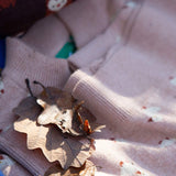 The soft pink Little Green Radicals knitted cardigan in puddle ducks with autumn leaves on top 