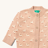 A close up of the Little Green Radicals knitted cardigan in puddle ducks showing the button detail and a close up of the white ducks on the soft pink GOTS organic cotton fabric and available at Babipur.