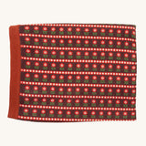 Little Green Radicals baby blanket in collecting flowers available at Babipur. A GOTS organic cotton blanket in brown with retro red flowers. Features a matching textured brown trim.