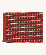 Little Green Radicals baby blanket in collecting flowers available at Babipur. A GOTS organic cotton blanket in brown with retro red flowers. Features a matching textured brown trim.
