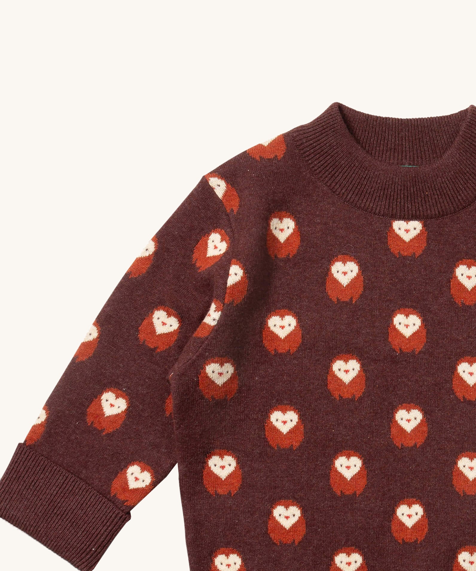 A close up of the  Little Green Radicals brown owl knitted jumper available at Babipur. Showing the owl detail and the thick collar on brown organic cotton fabric