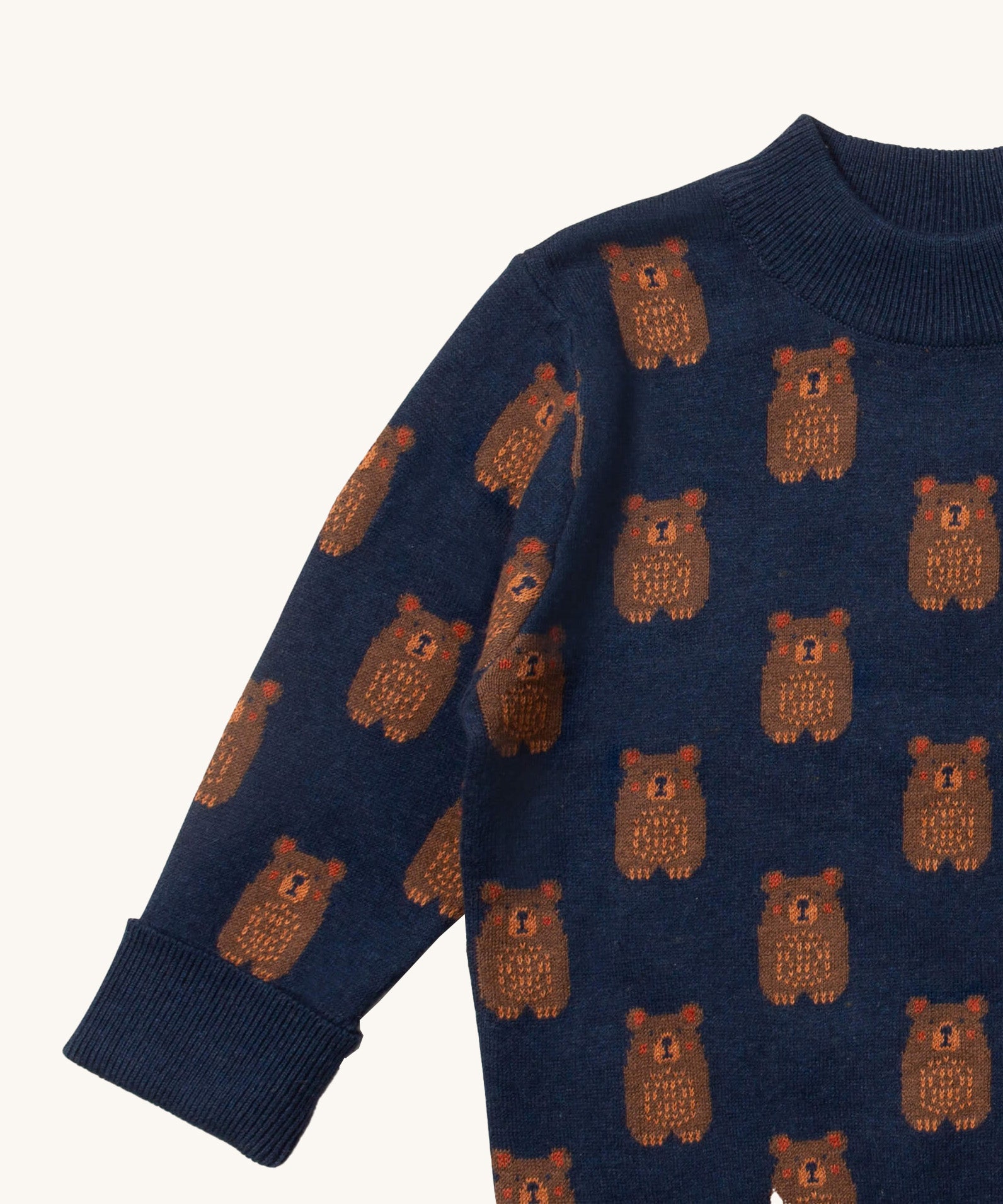 A close up of the Little Green Radicals navy teddy bears knitted jumper showing the collar and cuff detail on navy organic cotton fabric. 