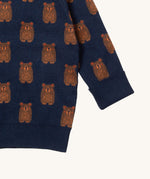A close up of the Little Green Radicals navy teddy bears knitted jumper showing the cute brown bear detail and thick cuff detail on navy organic cotton fabric. 