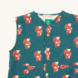 A close up of the Little Green Radicals reversible gilet in red foxes and sherpa lined. Showing the button detail and a close up of the cute fox print on GOTS organic cotton fabric. 