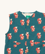 A close up of the Little Green Radicals reversible gilet in red foxes and sherpa lined. Showing the button detail and a close up of the cute fox print on GOTS organic cotton fabric. 