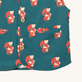 A close up of the Little Green Radicals reversible gilet in red foxes and sherpa lined. Showing the pouch pocket detail and a close up of the cute fox print on GOTS organic cotton fabric. 