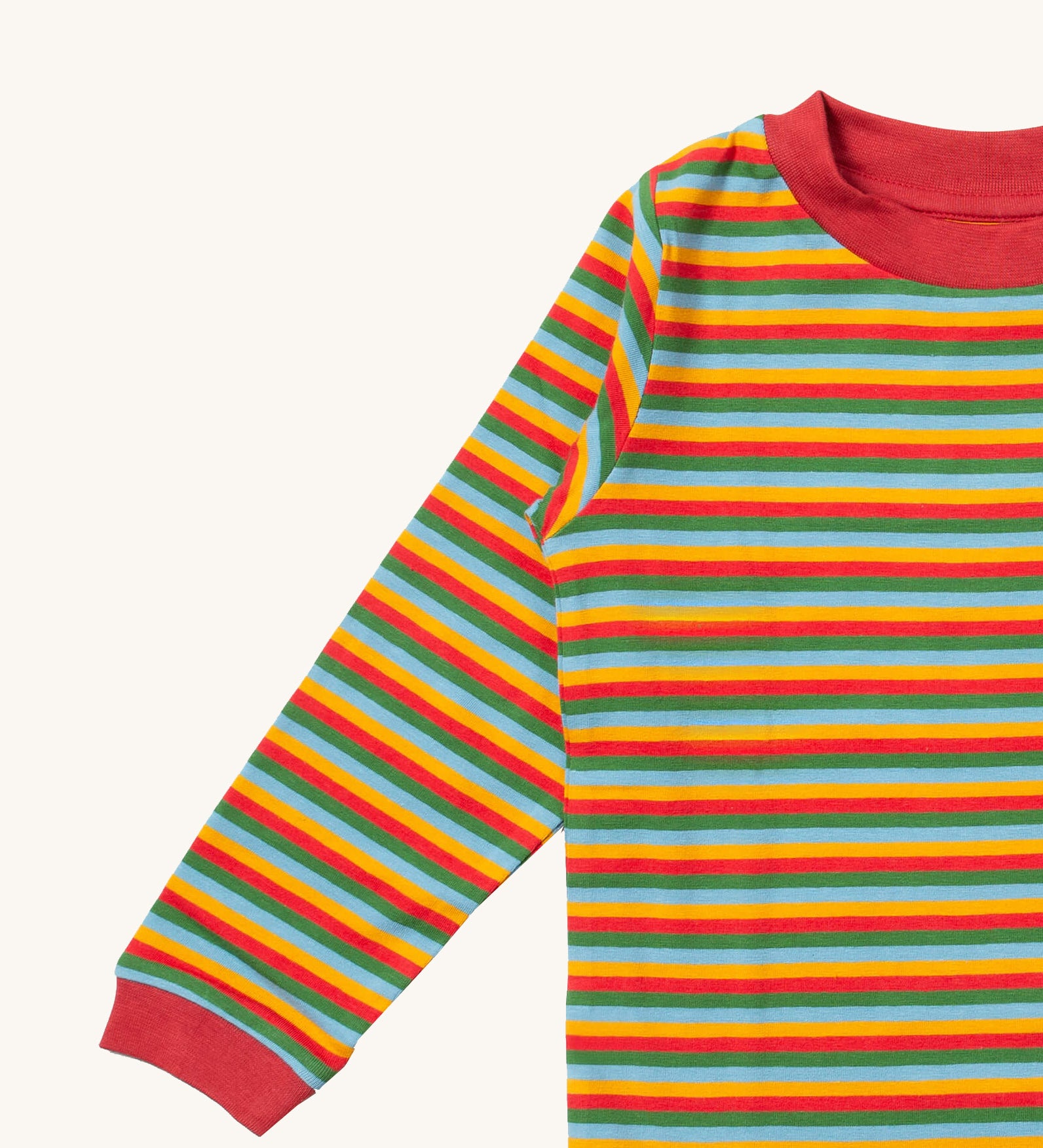 A close up of the Little Green Radicals autumn rainbow striped long sleeve top that's available at Babipur. Showing the autumn inspired coloured stripes detail on organic cotton fabric.
