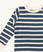 A close up of the Little Green Radicals midnight blue striped long sleeve top that's available at Babipur. Showing the navy and white stripe detail on organic cotton fabric.