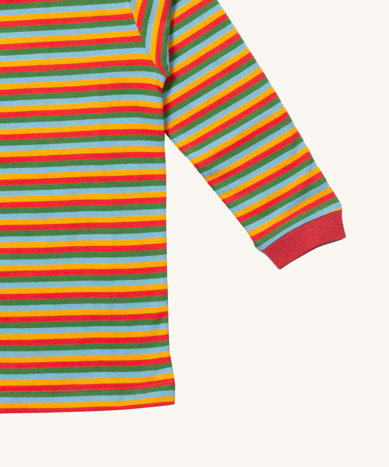 A close up of the Little Green Radicals autumn rainbow striped long sleeve top that's available at Babipur. Showing the red cuff detail on striped organic cotton fabric.