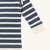 A close up of the Little Green Radicals midnight blue striped long sleeve top that's available at Babipur. Showing the white cuff detail on striped organic cotton fabric.