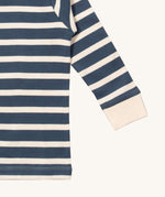 A close up of the Little Green Radicals midnight blue striped long sleeve top that's available at Babipur. Showing the white cuff detail on striped organic cotton fabric.