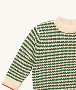 A close up of the Little Green Radicals snuggly knitted jumper in olive stripe. Showing the cream and green stripe knit detail and the matching cream collar and turned up cuff