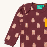 A close up of the Little Green Radicals teddy bear sleeve t-shirt. Showing the cute brown bear print and collar detail on dark maroon organic cotton fabric.