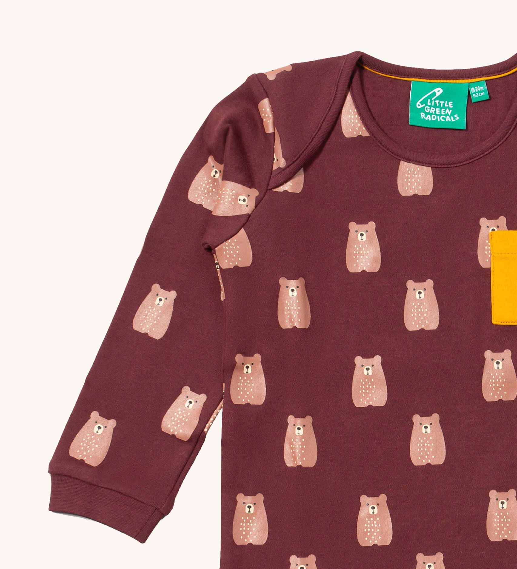A close up of the Little Green Radicals teddy bear sleeve t-shirt. Showing the cute brown bear print and collar detail on dark maroon organic cotton fabric.