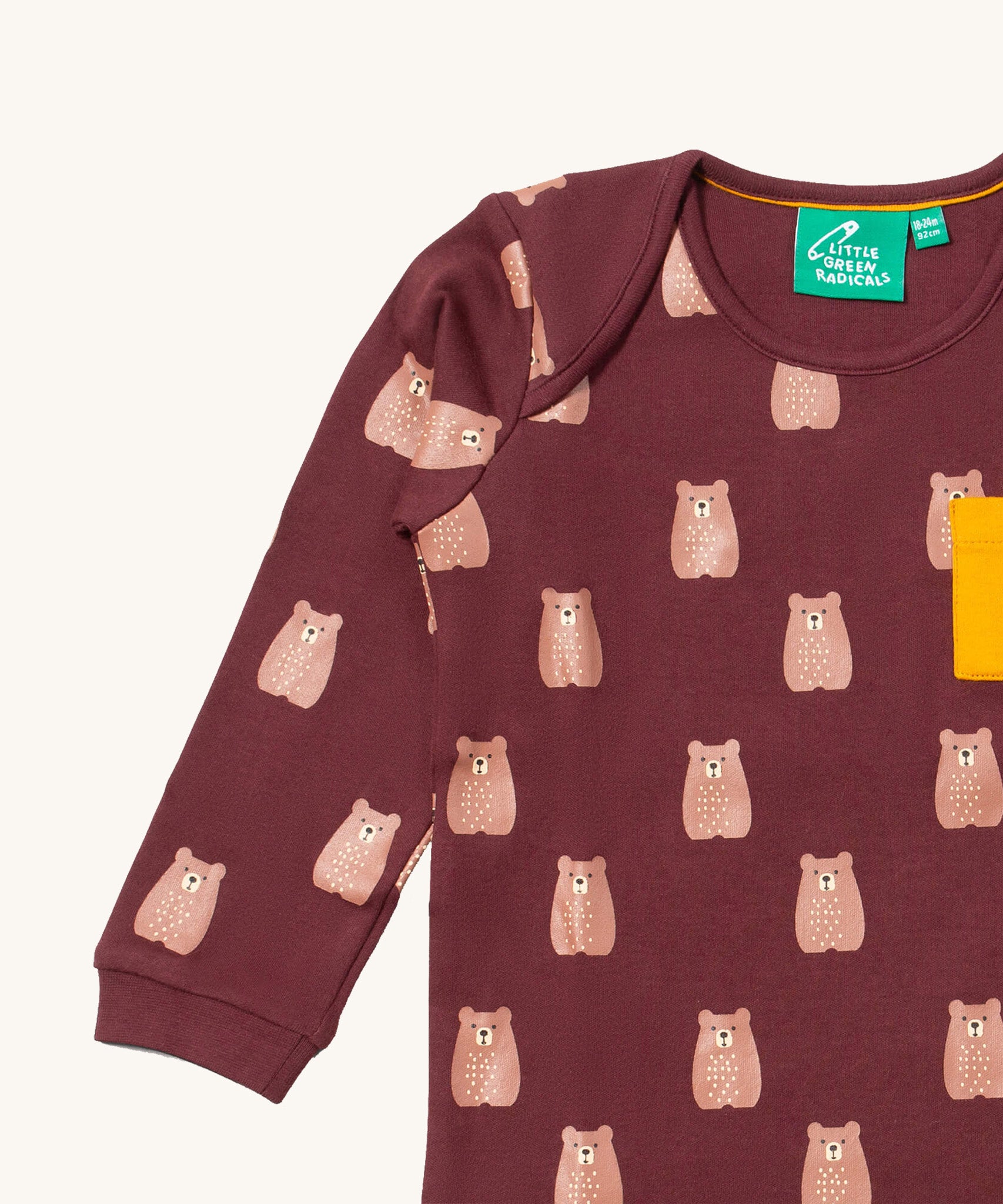 A close up of the Little Green Radicals teddy bear sleeve t-shirt. Showing the cute brown bear print and collar detail on dark maroon organic cotton fabric.