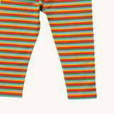A close up of the Little Green Radicals rainbow striped organic leggings. Showing the rainbow striped design  and leg cuff detail on organic cotton fabric