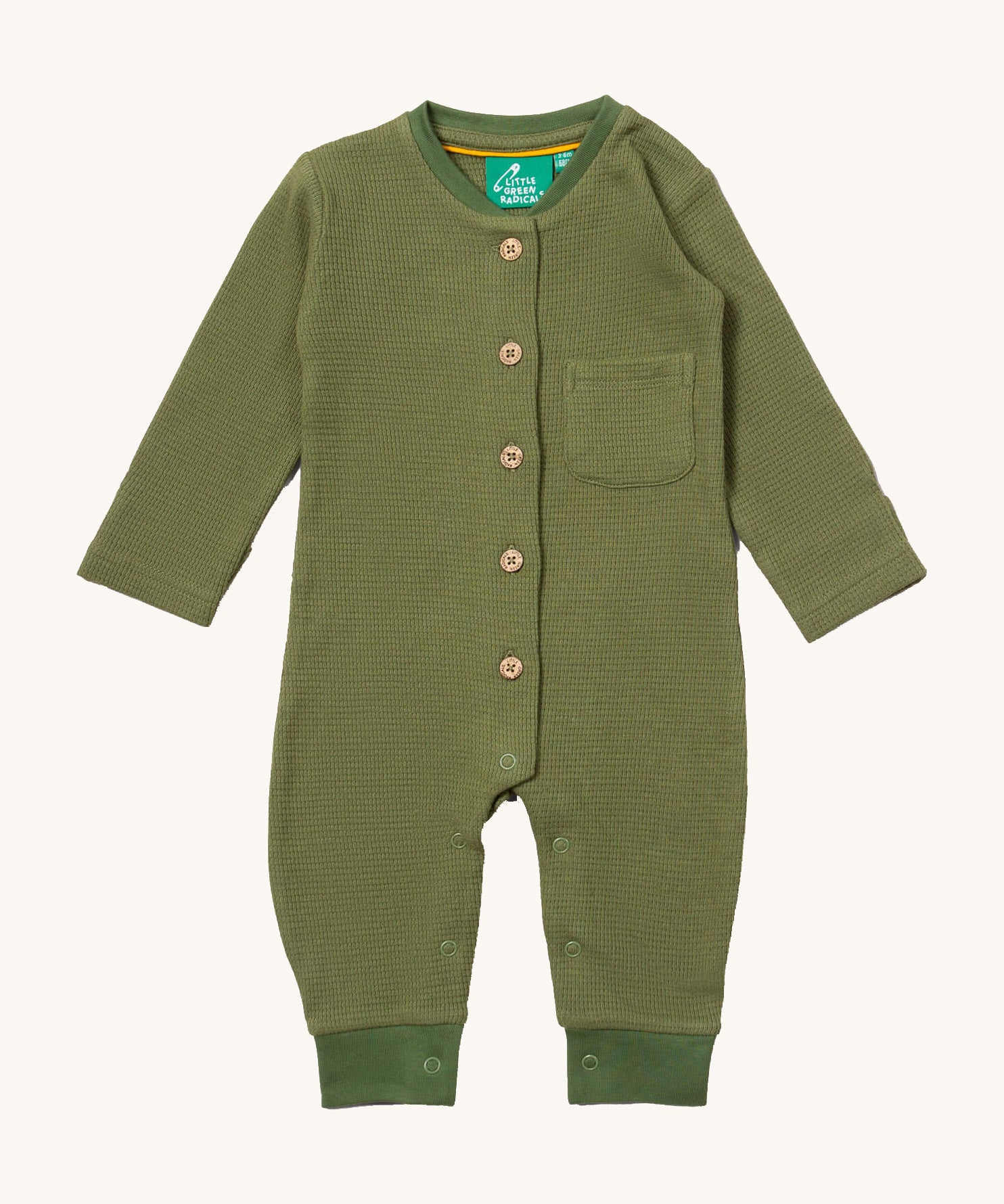 Little Green Radicals green chive waffle playsuit available at Babipur. A GOTS organic cotton all in one in a waffle knit style. Features button fasteners on the front and poppers around the crotch with a small pouch chest pocket