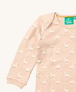 A close up of the Little Green Radicals puddle ducks sleeve t-shirt. Showing the cute duck prints collar trim detail on peach organic cotton fabric.
