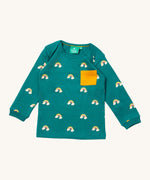 Little Green Radicals turquoise rainbow t-shirt. A GOTS organic cotton top with long sleeves in turquoise with prints of rainbows on clouds and a yellow chest pocket.