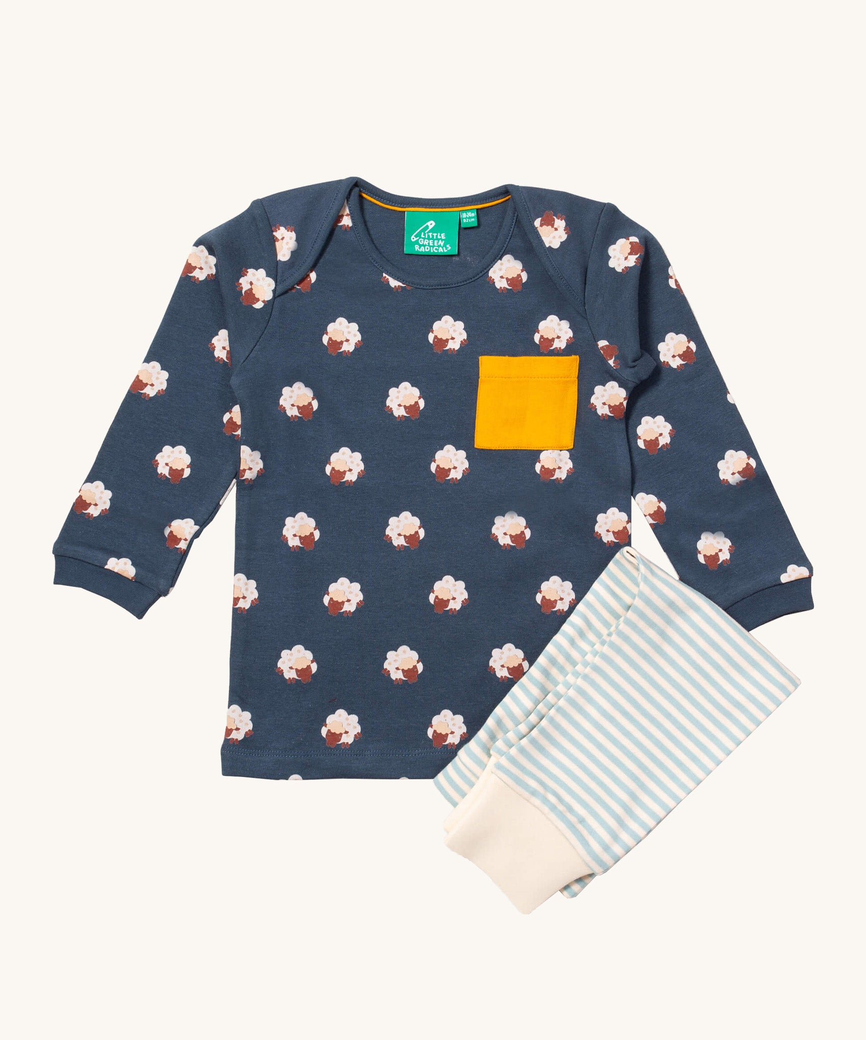 Little Green Radicals sleeping sheep playset available at Babipur. Features a GOTS organic cotton long sleeve t-shirt in navy with prints of cute sheep with a yellow chest pocket and a striped jogger in light blue and cream.