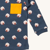 A close up of the Little Green Radicals sleeping sheep sleeve t-shirt. Showing the cute sheep print and yellow chest pocket detail on navy organic cotton fabric.
