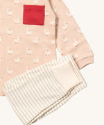 A close up of the Little Green Radicals grey and cream striped jogger on top of the puddle ducks long sleeve t-shirt on organic cotton fabric