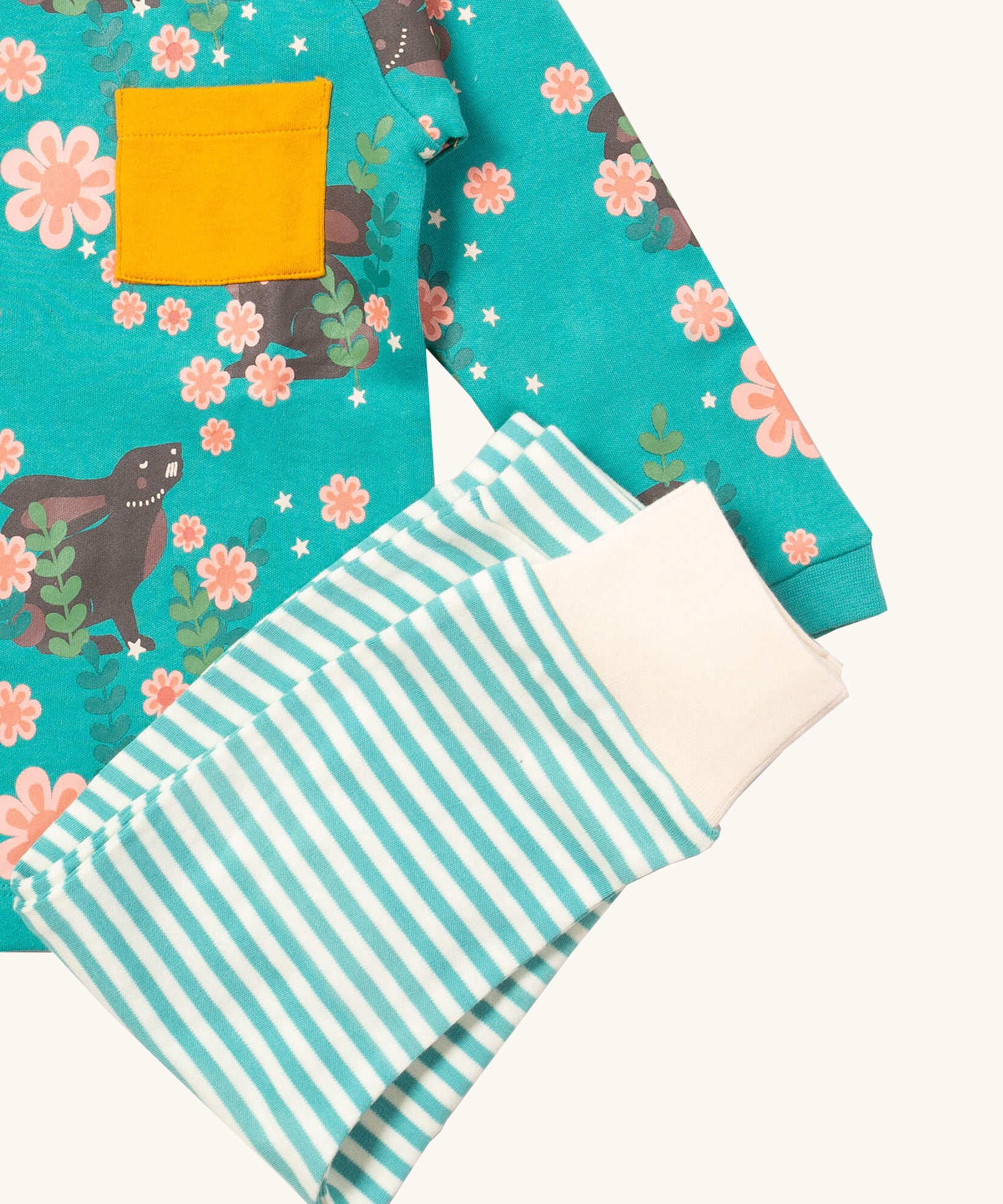 A close up of the Little Green Radicals light blue striped  jogger on top of the winter rabbit long sleeve t-shirt. Showing the soft elasticated leg cuff detail on organic cotton fabric
