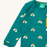 A close up of the Little Green Radicals turquoise rainbows long sleeve t-shirt. Showing the rainbow on clouds print and collar detail on turquoise organic cotton fabric.