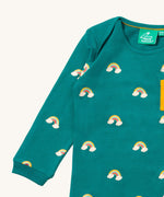 A close up of the Little Green Radicals turquoise rainbows long sleeve t-shirt. Showing the rainbow on clouds print and collar detail on turquoise organic cotton fabric.