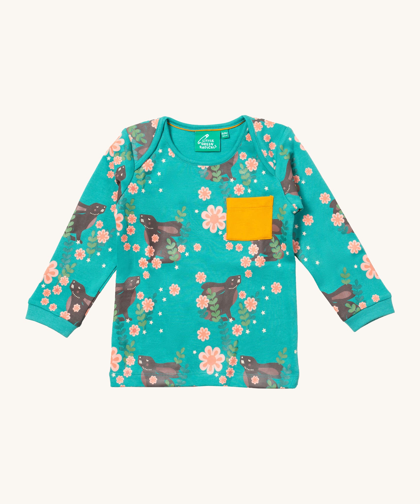 Little Green Radicals winter rabbits t-shirt available at Babipur. A GOTS organic cotton top with long sleeves in turquoise with prints of rabbits in pink flowers and a yellow chest pocket.