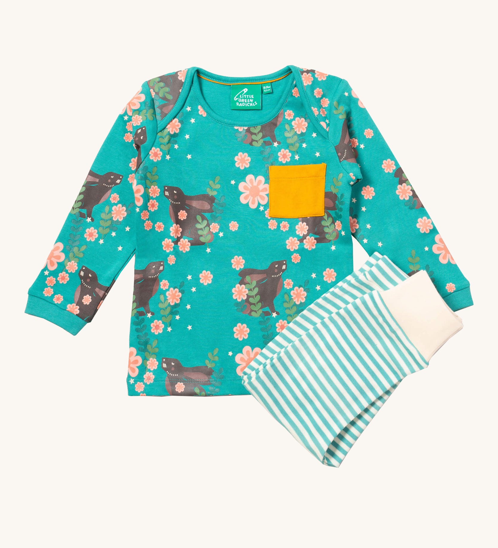 Little Green Radicals winter rabbits playset available at Babipur. Features a GOTS organic cotton long sleeve t-shirt in light turquoise with prints of rabbits in pink flowers with  a yellow chest pocket and a striped jogger in light turquoise and cream.
