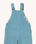 A close up of the Little Green Radicals pale blue lined corduroy dungarees. Showing the back pocket detail on blue corduroy organic cotton fabric