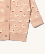 A close up of the Little Green Radicals knitted cardigan in puddle ducks showing the button detail and a close up of the white cuff and hem detail on soft pink GOTS organic cotton fabric and available at Babipur.