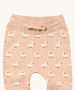 A close up of the Little Green Radicals puddle ducks knitted leggings showing the elasticated waist band and drawstring detail on light pink organic cotton fabric