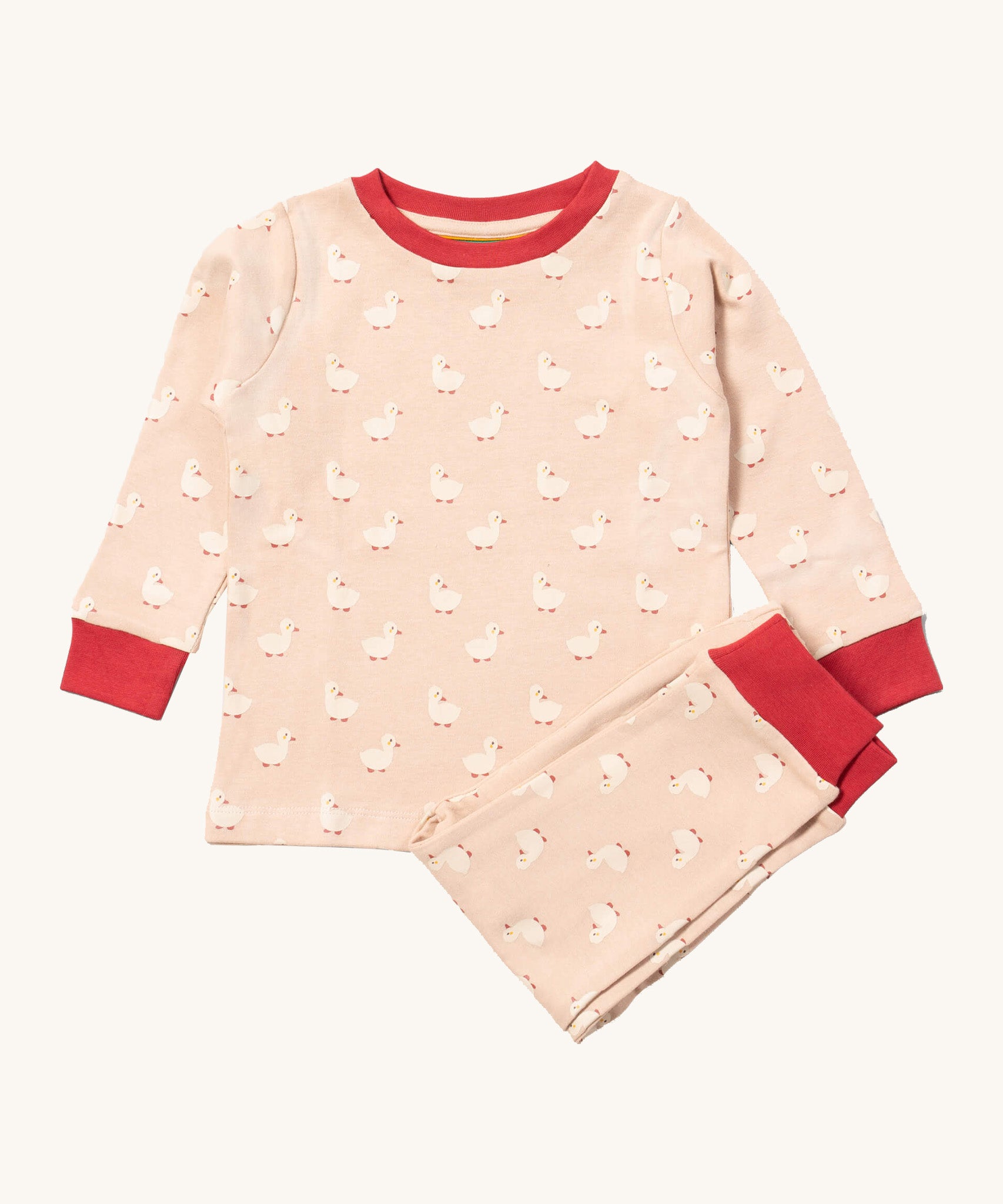 Little Green Radicals puddle ducks pyjama set available at Babipur.. A GOTS organic cotton pyjama top and bottom set in light pink with red trim and cute duck prints.